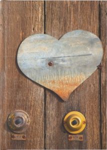 Doorbells and Metal Heart on Wooden Fence