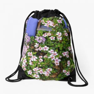 Pink and Purple Flowers Around Base of Blue Fence - drawstring bag